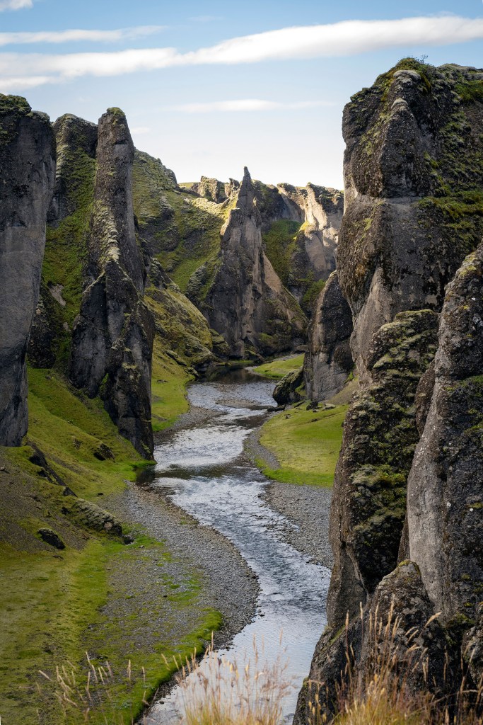 River flowing through a dramatic canyon landscape in Iceland.