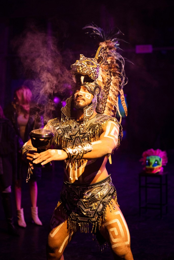 Performer wearing an elaborate traditional Mexican costume during a live performance.